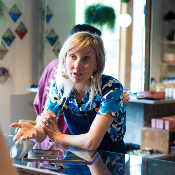 a store owner converses with a customer