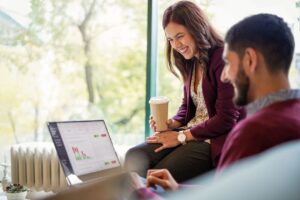 a man and a woman looking at a laptop