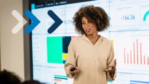 A woman presents in front of a screen.