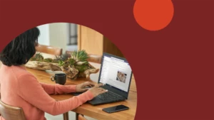 a woman sitting at a table using a laptop