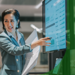 A woman points at a computer screen.