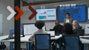 A group of security professionals gather around a computer.