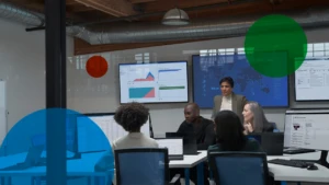 a group of people sitting at a desk in front of a computer