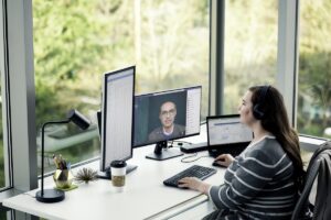 Female enterprise employee working remotely from home on a Lenovo device, running Microsoft Teams.