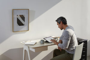 Adult male in home office environment using Microsoft OneNote at a desk with a black Microsoft Surface Pro 7 in studio mode.