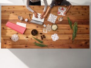 Parent making holiday cards with child.