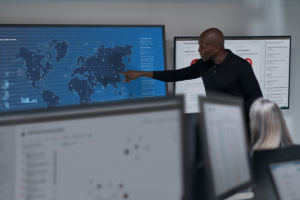 a man standing in front of a computer screen