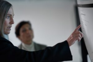 Chief information security officer collaborating with a practitioner in a security operations center.