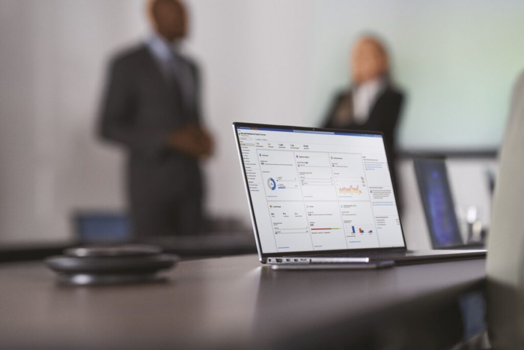 Camera focused on laptop screen showing security dashboard while security decision makers present to the board of executives on security topics.