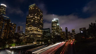 Photograph of time-lapse of nighttime traffic around a city core​