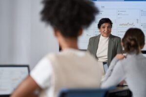 CISO (chief information security officer) presents to the board of executives on security topics in a conference room setting.