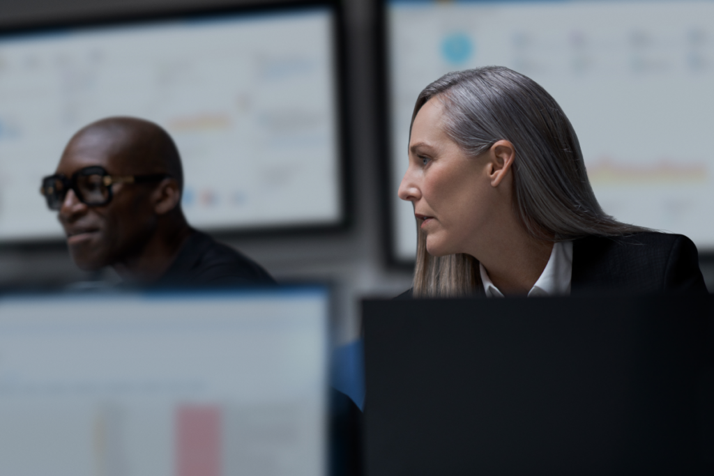 CISO (chief information security officer) collaborating with a practitioner in a security operations center.