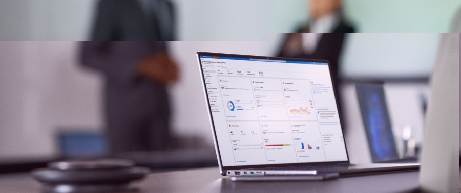 Camera focused on laptop screen showing security dashboard while security decision makers present to the board of executives on security topics.