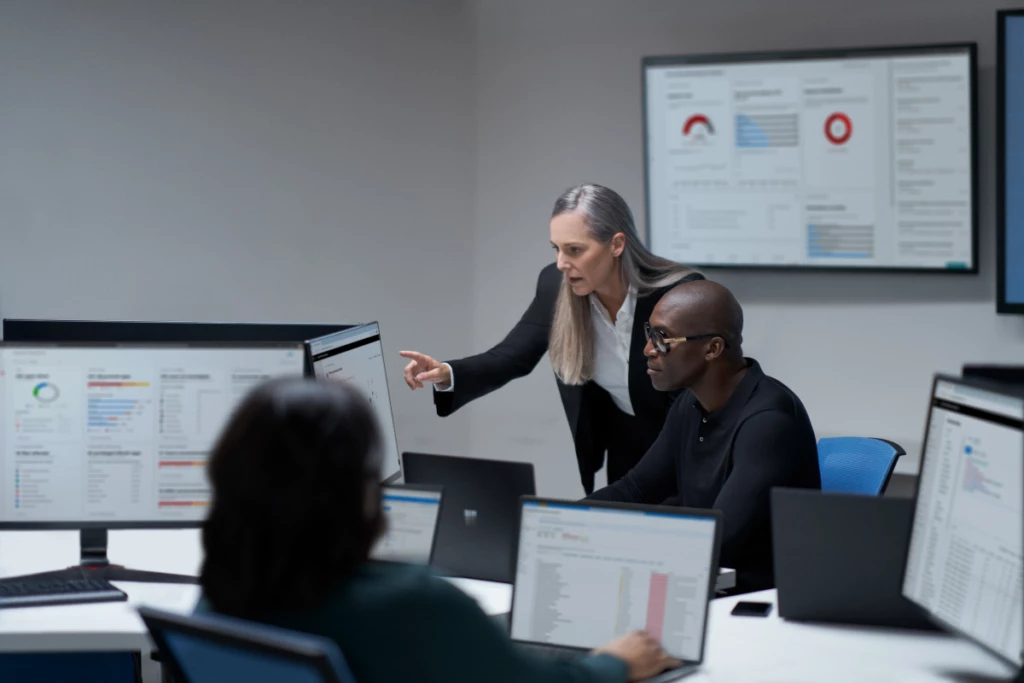 Chief information security officer collaborating with a practitioner in a security operations center.