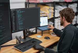 a man sitting at a desk in front of a computer