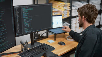 a man sitting at a desk in front of a computer