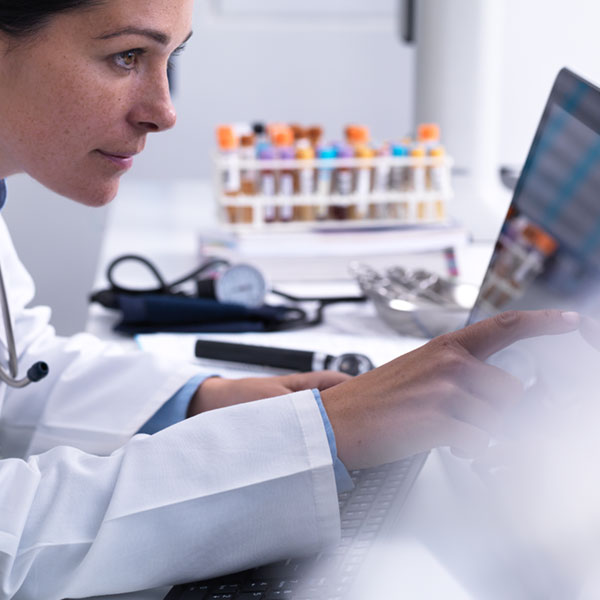 A doctor points at data on her Microsoft Surface screen