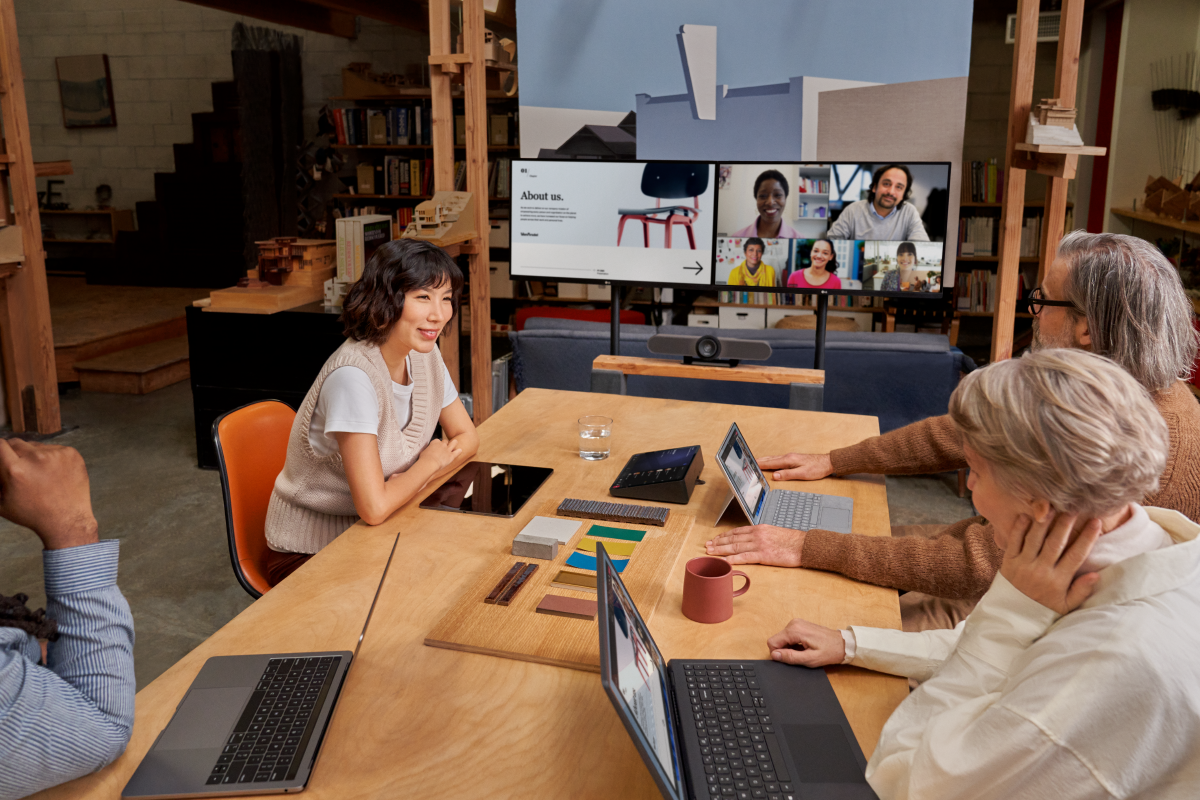 Group of coworkers collaborating in modern hybrid work space.