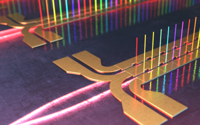 Illustration shows tiny columns of light in different colors standing vertically along circuits on a chip. 