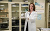 Elizabeth Gentry holding a kilogram test weight in the weights and measures training lab