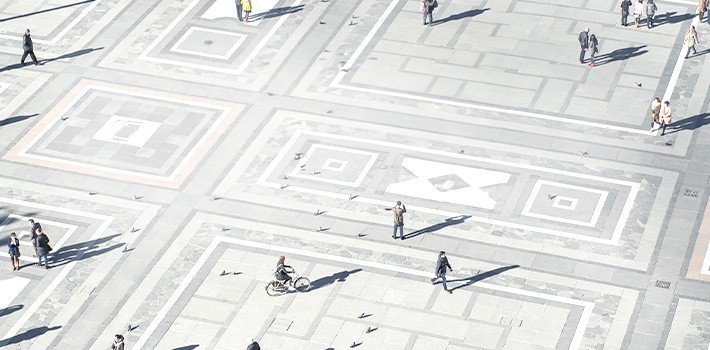 An aerial view of people walking on a street.