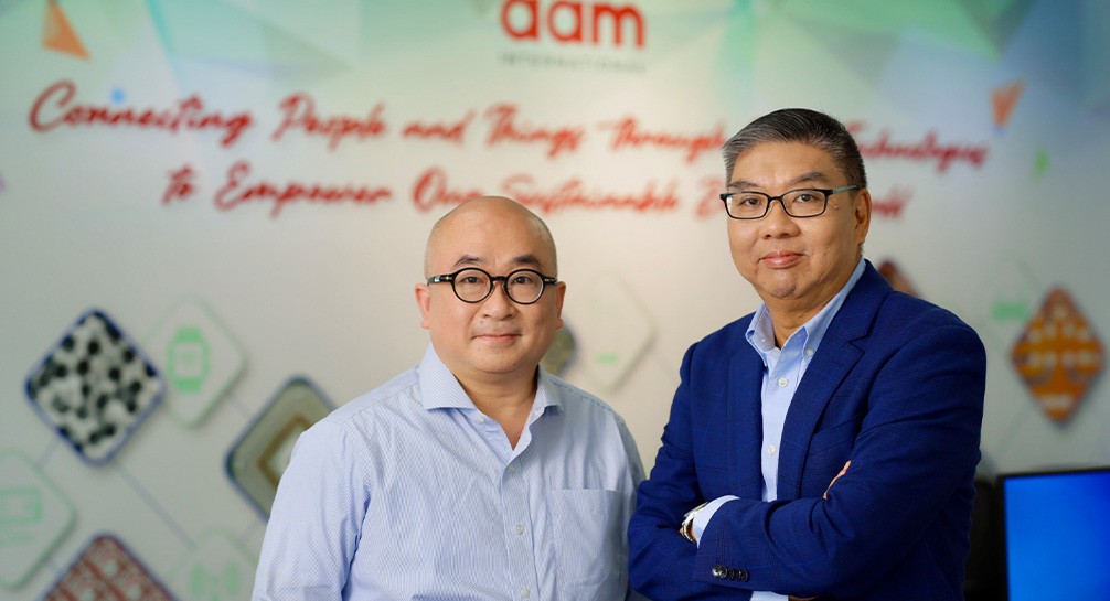 Two men standing next to each other in an office.