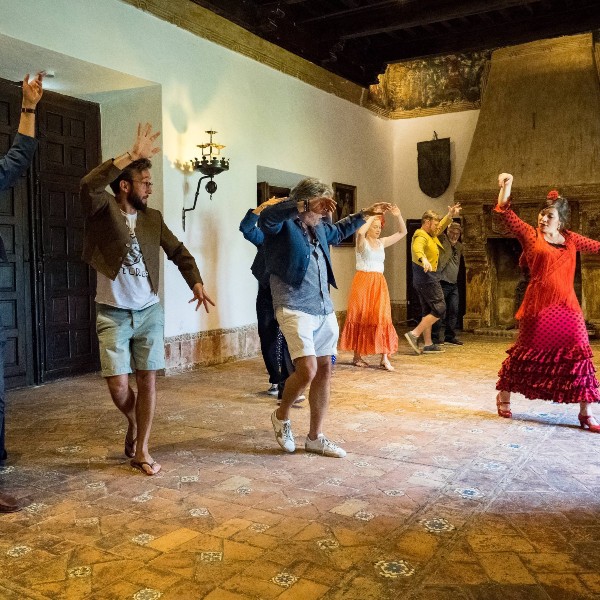 A group of people dancing in a room.