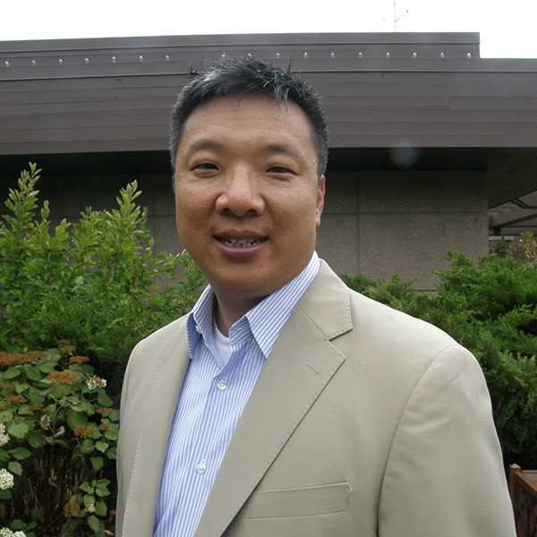 A man wearing a tan suit.