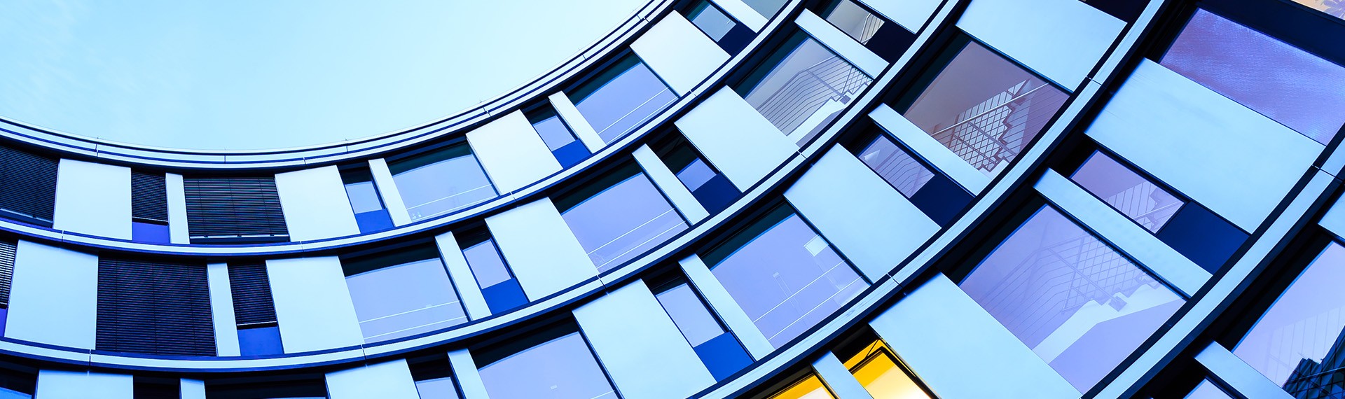 A building with many windows and a blue sky.