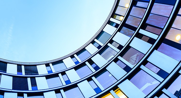 A circular building with a blue sky in the background.