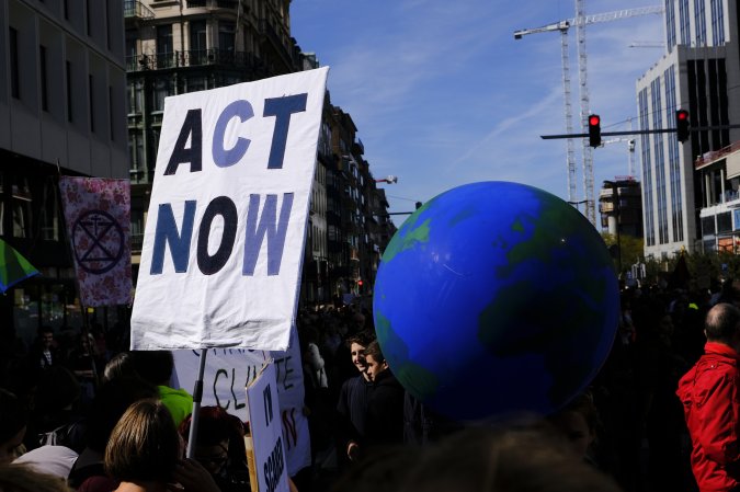 a large globe held up at a protest