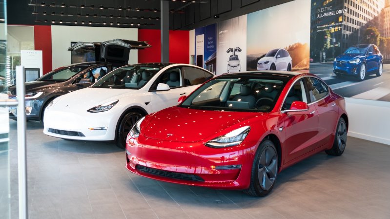 three tesla cars in a dealership