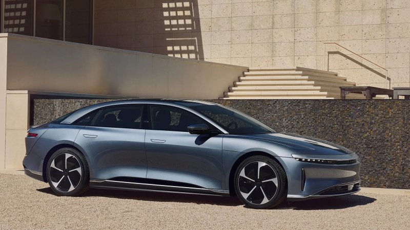 a sedan sitting in front of concrete structures