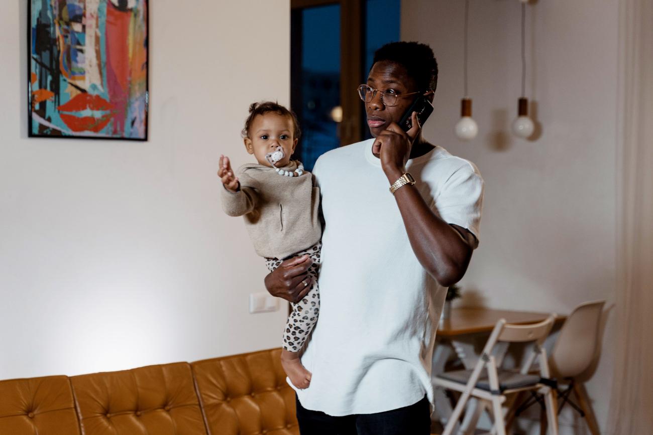 Man on telephone with baby