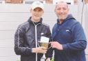 Jack Bushell, left, is presented with the trophy by Rob Lawrenson