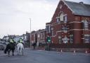 Mounted police officers patrol outside Southport Islamic Centre Mosque (James Speakman/PA)