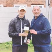 Jack Bushell, left, is presented with the trophy by Rob Lawrenson