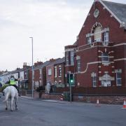 Mounted police officers patrol outside Southport Islamic Centre Mosque (James Speakman/PA)