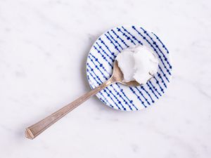 Coconut oil on a spoon and plate