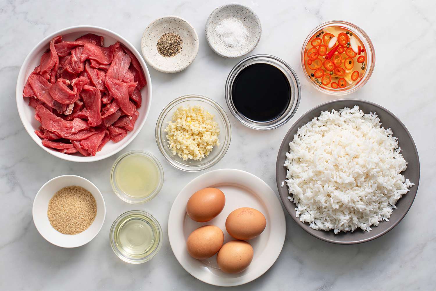 Tapsilog ingredients in bowls 