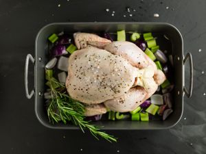 Raw chicken in roasting pan