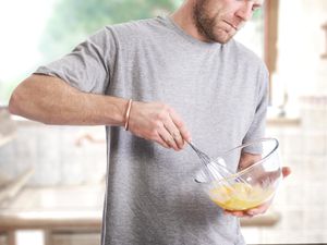 Man beating eggs with a whisk