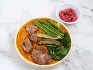  Freshly cooked Filipino food called Kare Kare or meat and vegetables cooked in savory thick peanut sauce.