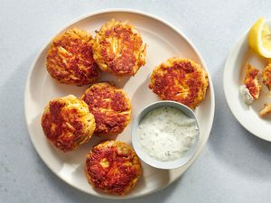 Keto Crab Cakes on a platter, with sauce in a small bowl 