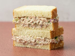 Tuna salad sandwich cut in half and stacked