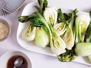 Roasted Bok Choy sliced in halves on a white platter 