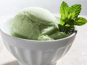 Lime sherbet in a bowl garnished with mint