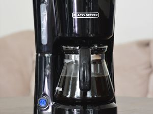 Black + Decker 5-Cup Coffeemaker displayed on wood table