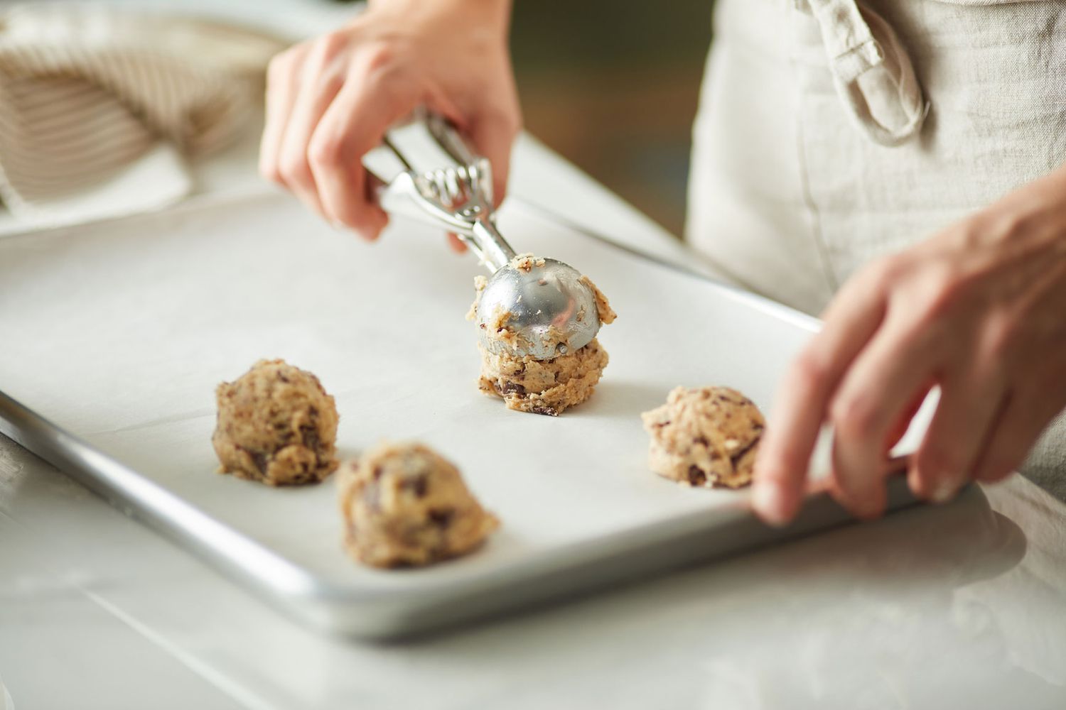 Scooping cookie dough onto a sheet pan