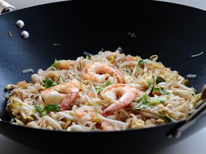 Phad Thai - stir-fried rice noodles with prawns in a wok